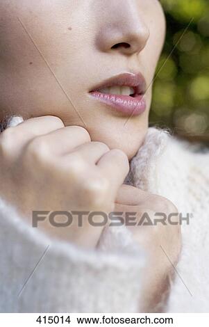 Picture - Close up of a woman wearing a white jumper. Fotosearch