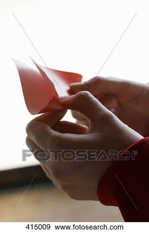 Close up of hands folding paper View Large Photo Image Stock Photo - Close up of hands folding paper. Fotosearch