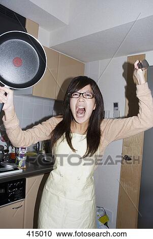 Woman screaming whilst holding kitchen knife and frying pan View Large Photo Image Stock Image - Woman screaming whilst holding kitchen knife and frying pan. Fotosearch