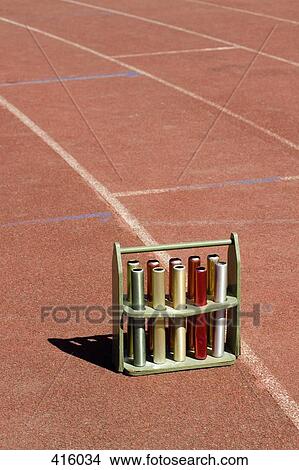 Crate of relay batons on a running track View Large Photo Image Picture - Crate of relay batons on a running track. Fotosearch