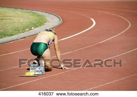Female athlete in starting blocks on a running track View Large Photo Image Stock Photo - Female athlete in starting blocks on a running track. Fotosearch
