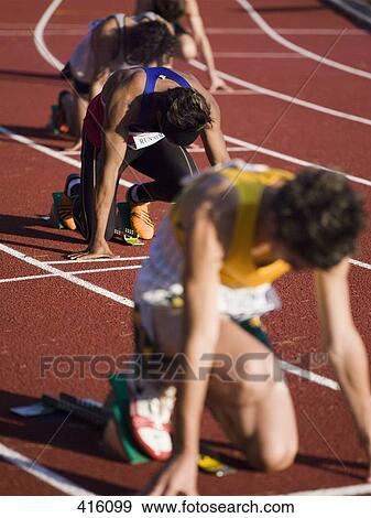 Group of male athletes in starting blocks on a running track View Large Photo Image Stock Photo - Group of male athletes in starting blocks on a running track. Fotosearch