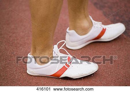 Low section of a male athlete standing on a running track View Large Photo Image Stock Image - Low section of a male athlete standing on a running track. Fotosearch