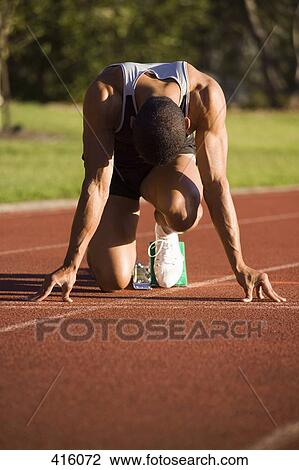 Male athlete in starting blocks on a running track View Large Photo Image Stock Image - Male athlete in starting blocks on a running track. Fotosearch
