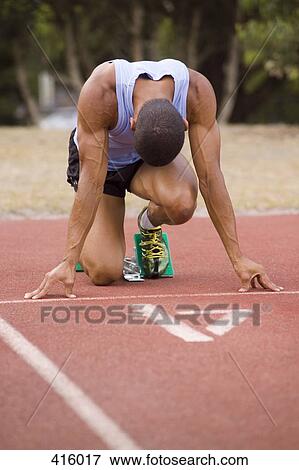 Male athlete in starting blocks on a running track View Large Photo Image Stock Photo - Male athlete in starting blocks on a running track. Fotosearch