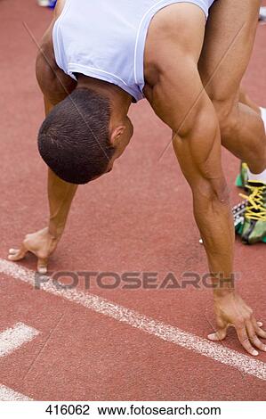 Male athlete in starting position on a running track View Large Photo Image Stock Image - Male athlete in starting position on a running track. Fotosearch