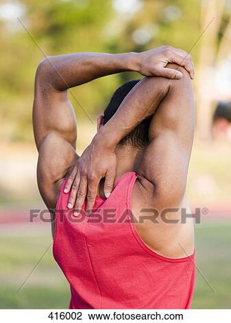 Male athlete stretching View Large Photo Image Stock Image - Male athlete stretching. Fotosearch