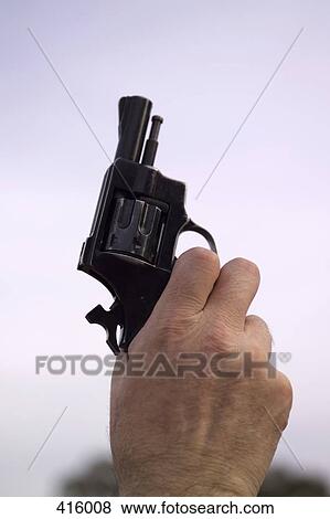 Stock Photo - Man holding a starting gun. Fotosearch