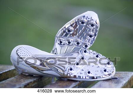 Pair of running spikes on a bench View Large Photo Image Stock Photo - Pair of running spikes on a bench. Fotosearch