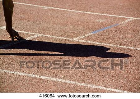 Shadow of a runner in the starting position on a track View Large Photo Image Picture - Shadow of a runner in the starting position on a track. Fotosearch