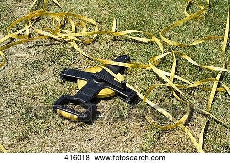 Stock Photo - Tape measure unraveled on grass. Fotosearch
