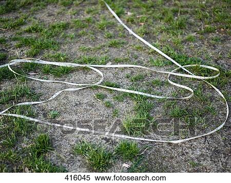 Tape measure unraveled on the ground View Large Photo Image Stock Photography - Tape measure unraveled on the ground. Fotosearch