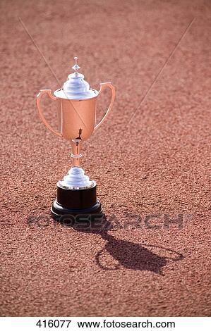 Trophy on the ground at a sports track View Large Photo Image Stock Photo - Trophy on the ground at a sports track. Fotosearch