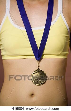 Young woman wearing a gold medal View Large Photo Image Picture - Young woman wearing a gold medal. Fotosearch