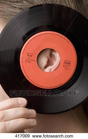 Man holding record to his ear View Large Photo Image Stock Photo - Man holding record to his ear. Fotosearch