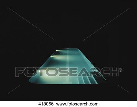 Stock Photograph - A swimming pool lit at night. Fotosearch