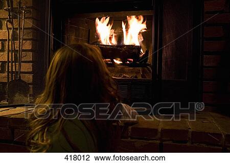 A young girl looking at a fire View Large Photo Image Stock Image - A young girl looking at a fire. Fotosearch