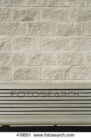 Grey seat in front of a grey wall View Large Photo Image Stock Image - Grey seat in front of a grey wall. Fotosearch