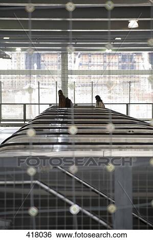 People on escalators View Large Photo Image Stock Photograph - People on escalators. Fotosearch