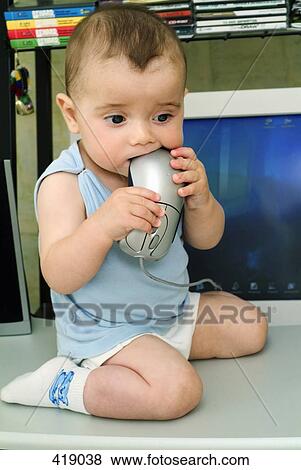 Baby boy putting computer mouse in his mouth View Large Photo Image Stock Photo - Baby boy putting computer mouse in his mouth. Fotosearch