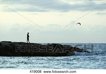 Man looking out to sea View Large Photo Image Stock Photo - Man looking out to sea. Fotosearch
