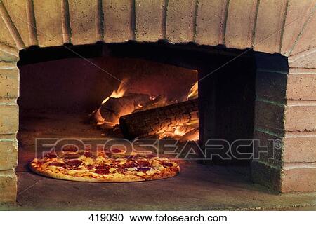 Pizza cooking in stone oven View Large Photo Image Stock Image - Pizza cooking in stone oven. Fotosearch