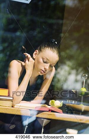 Stock Photograph - Woman sitting in a cafe. Fotosearch