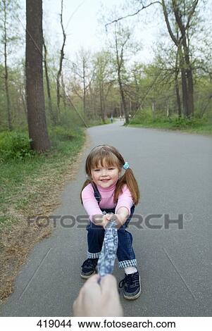 Young girl pulling on cloth View Large Photo Image Picture - Young girl pulling on cloth. Fotosearch