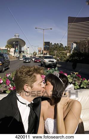 Bride and groom kissing in the back seat of a convertible car View Large Photo Image Stock Image - Bride and groom kissing in the back seat of a convertible car. Fotosearch
