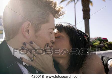 Bride and groom kissing in the back seat of a convertible car View Large Photo Image Stock Photo - Bride and groom kissing in the back seat of a convertible car. Fotosearch