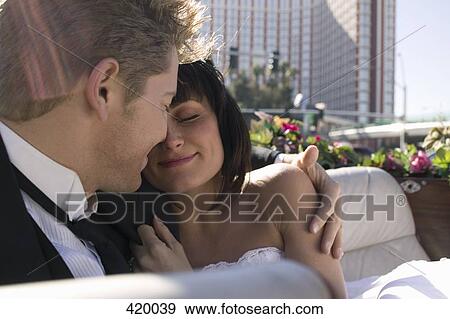 Bride and groom sitting together in a convertible car View Large Photo Image Stock Photo - Bride and groom sitting together in a convertible car. Fotosearch