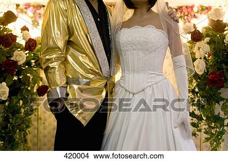 Picture - Bride and groom standing together at the altar. Fotosearch
