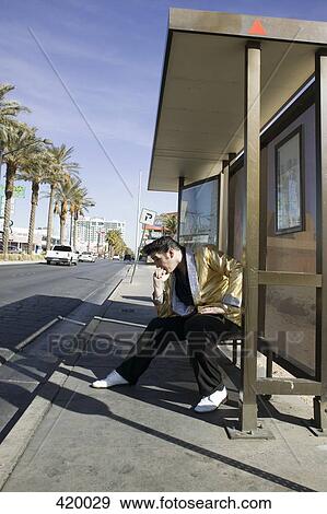 Elvis impersonator posing at a bus stop View Large Photo Image Stock Photo - Elvis impersonator posing at a bus stop. Fotosearch