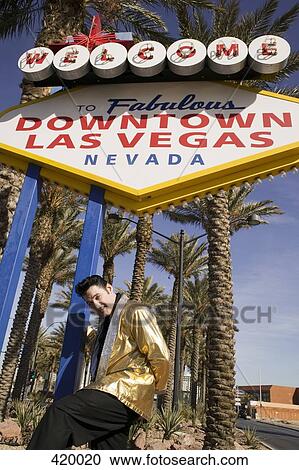 Elvis impersonator posing below the "Welcome to fabulous Las Vegas" sign View Large Photo Image Stock Image - Elvis impersonator posing below the "Welcome to fabulous Las Vegas" sign. Fotosearch