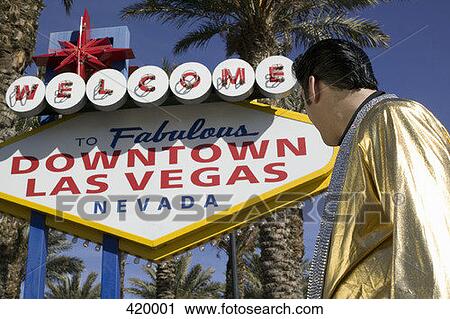 Elvis impersonator standing below the "Welcome to fabulous Las Vegas" sign View Large Photo Image Stock Image - Elvis impersonator standing below the "Welcome to fabulous Las Vegas" sign. Fotosearch