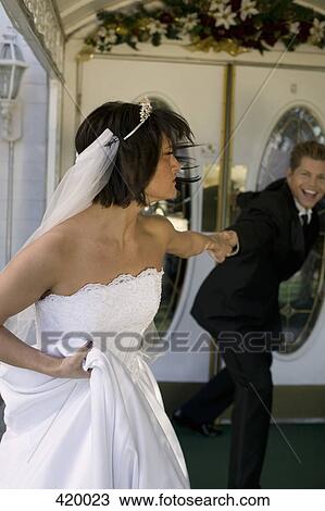 Groom dragging bride into a wedding chapel View Large Photo Image Stock Image - Groom dragging bride into a wedding chapel. Fotosearch