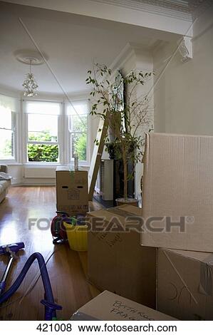 Cardboard boxes and furniture packed up for moving house View Large Photo Image Stock Photo - Cardboard boxes and furniture packed up for moving house. Fotosearch