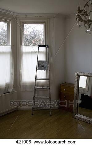 Ladder in front of a window whilst moving house View Large Photo Image Stock Photograph - Ladder in front of a window whilst moving house. Fotosearch