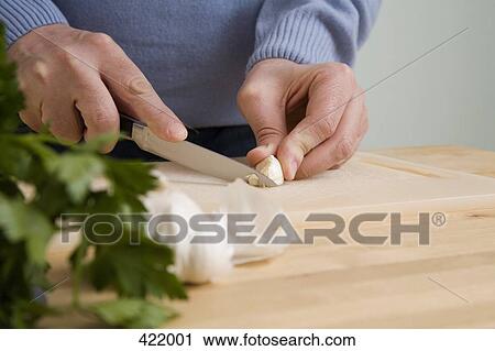 A man chopping garlic View Large Photo Image Stock Image - A man chopping garlic. Fotosearch