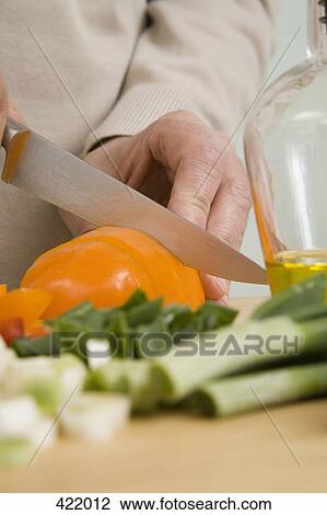 A man chopping vegetables View Large Photo Image Stock Image - A man chopping vegetables. Fotosearch