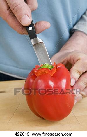 A man cutting a red bell pepper View Large Photo Image Stock Image - A man cutting a red bell pepper. Fotosearch