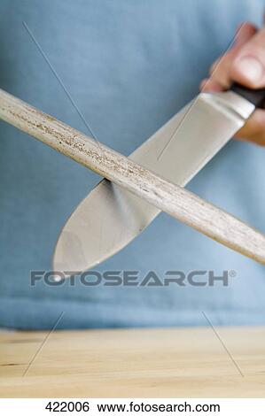 A man sharpening a kitchen knife with a steel View Large Photo Image Stock Photograph - A man sharpening a kitchen knife with a steel. Fotosearch