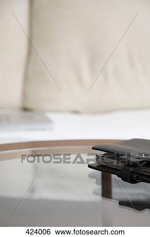 Personal organizer on a glass coffee table in front of a sofa View Large Photo Image Stock Photograph - Personal organizer on a glass coffee table in front of a sofa. Fotosearch