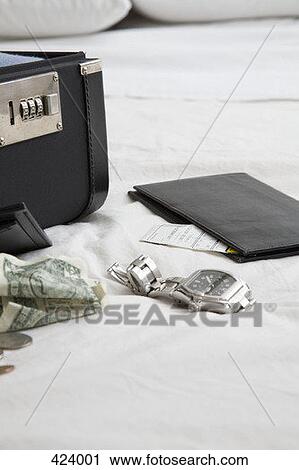 Wallet, money, a wristwatch and a briefcase on a bed View Large Photo Image Stock Image - Wallet, money, a wristwatch and a briefcase on a bed. Fotosearch