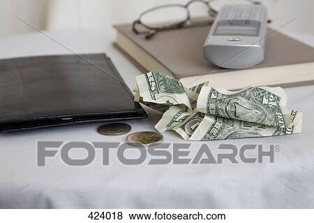 Wallet, money, cordless phone, book and reading glasses on a bedside table View Large Photo Image Stock Photo - Wallet, money, cordless phone, book and reading glasses on a bedside table. Fotosearch