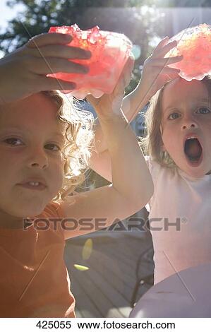 Two girls holding bowls of jello above their heads View Large Photo Image Stock Photography - Two girls holding bowls of jello above their heads. Fotosearch