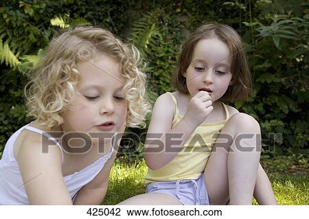 Stock Image - Two young girls at a picnic. Fotosearch