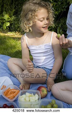 Young girl at a picnic View Large Photo Image Stock Photo - Young girl at a picnic. Fotosearch