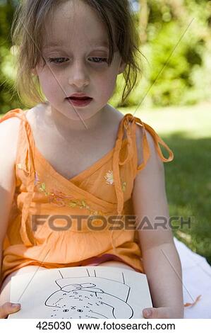 Young girl sitting in a backyard with a coloring book View Large Photo Image Stock Image - Young girl sitting in a backyard with a coloring book. Fotosearch