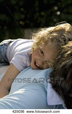 Young girl with her arms around her mother View Large Photo Image Stock Photograph - Young girl with her arms around her mother. Fotosearch